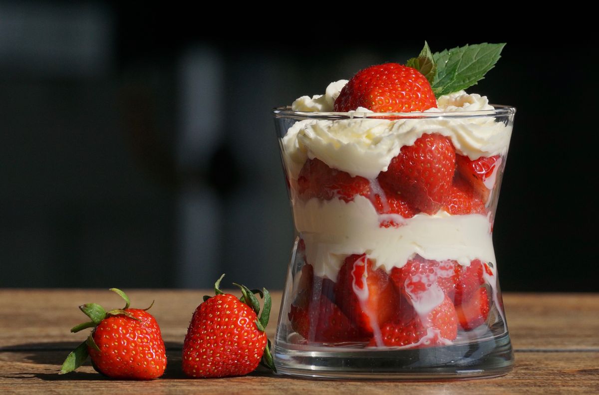 A layered yogurt and fruit dessert in a glass