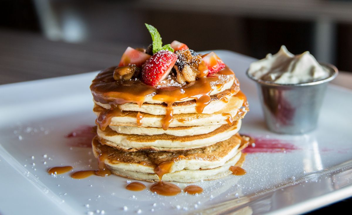 A stack of pancakes with fruit
